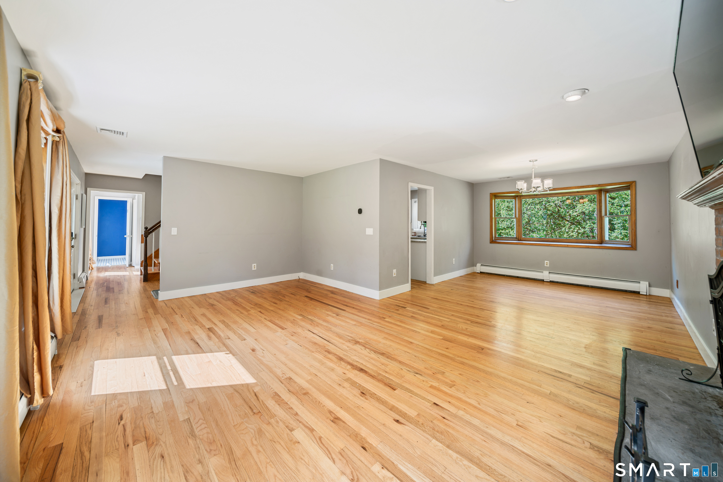 225 Bethmour Road Bethany, CT 06524 - Photo 4 of 30 Combination Living Room with wood burning fireplace & Dining Room with bay window