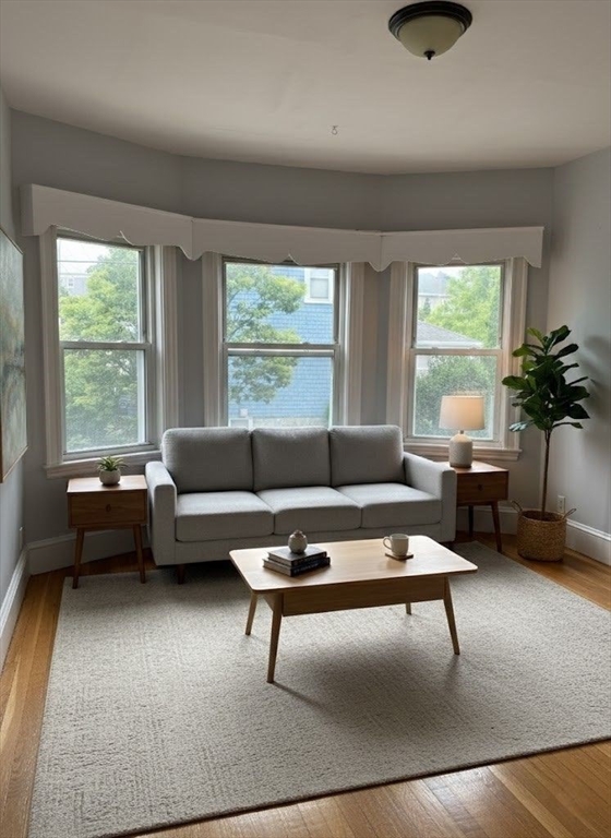 106 Beaumont Street, Unit 1 Boston, MA 02124 - Photo 1 of 15 a living room with furniture and a large window