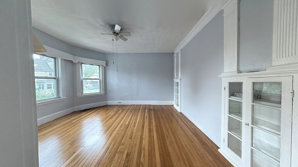 106 Beaumont Street, Unit 1 Boston, MA 02124 - Photo 12 of 15 wooden floor in an empty room with a window