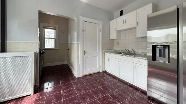 a kitchen with a stove a refrigerator and cabinets