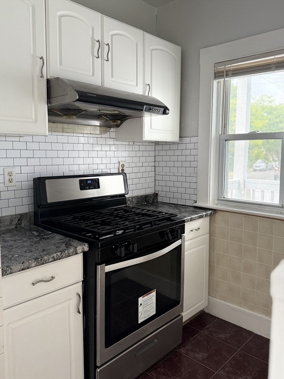 106 Beaumont Street, Unit 1 Boston, MA 02124 - Photo 6 of 15 a stove top oven sitting inside of a kitchen
