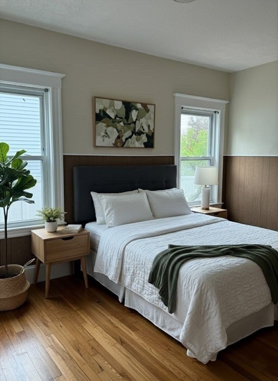 106 Beaumont Street, Unit 1 Boston, MA 02124 - Photo 9 of 15 a bedroom with a large bed and a couch