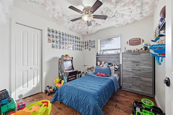 a bedroom with bed and wooden floor