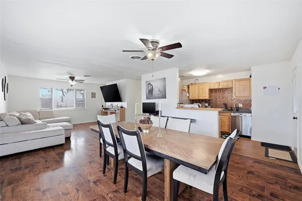 a view of a dining room with furniture and wooden floor