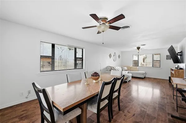 a view of a dining room with furniture and wooden floor