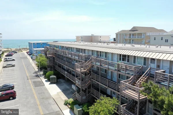 a view of a balcony with a lot of plants and wooden fence