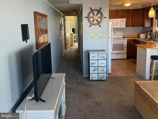 a kitchen with stainless steel appliances kitchen island a refrigerator sink and stove