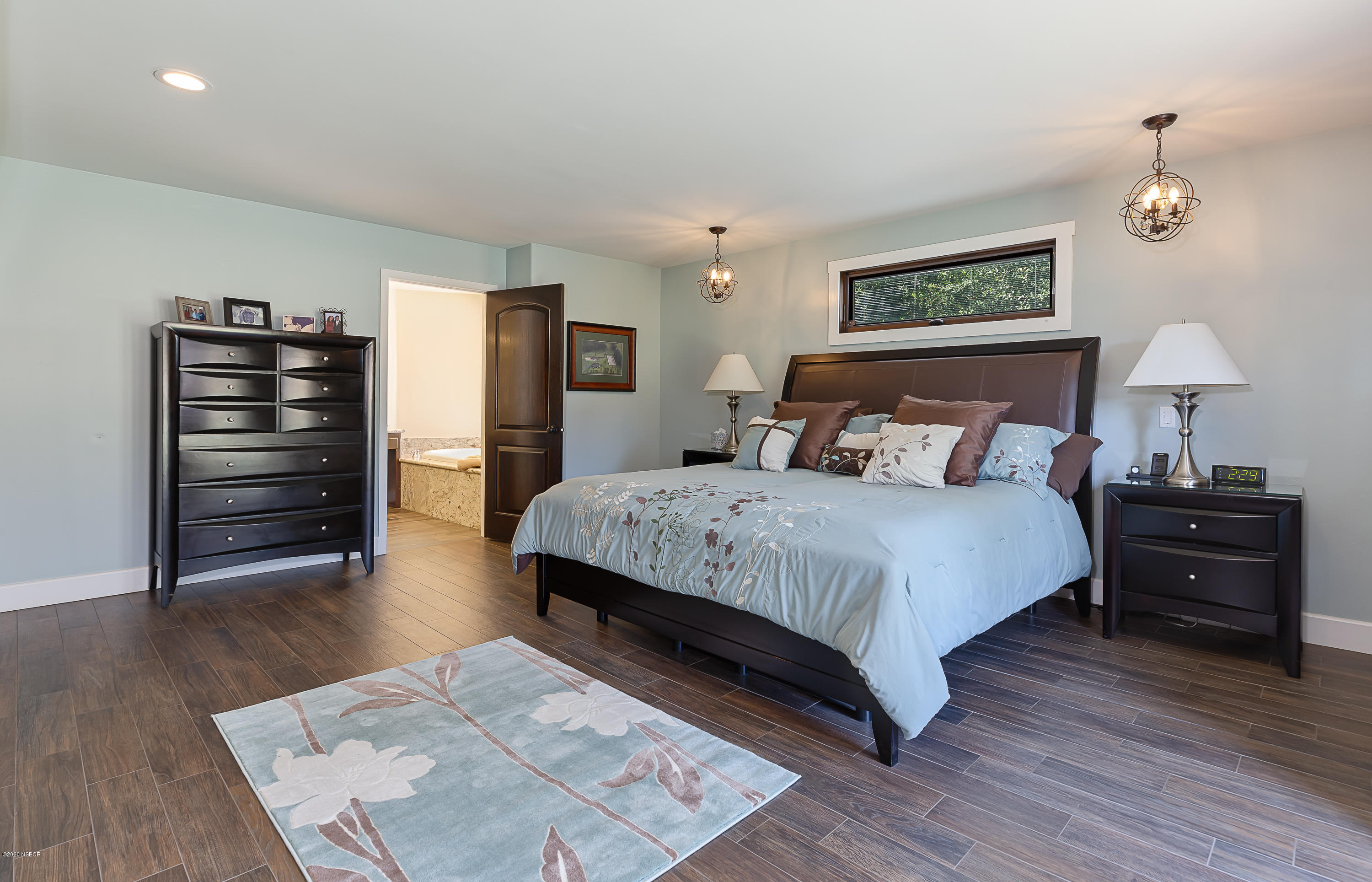 2550 Elk Grove Road Solvang, CA 93463 - Photo 11 of 28 a bedroom with a bed and wooden floor