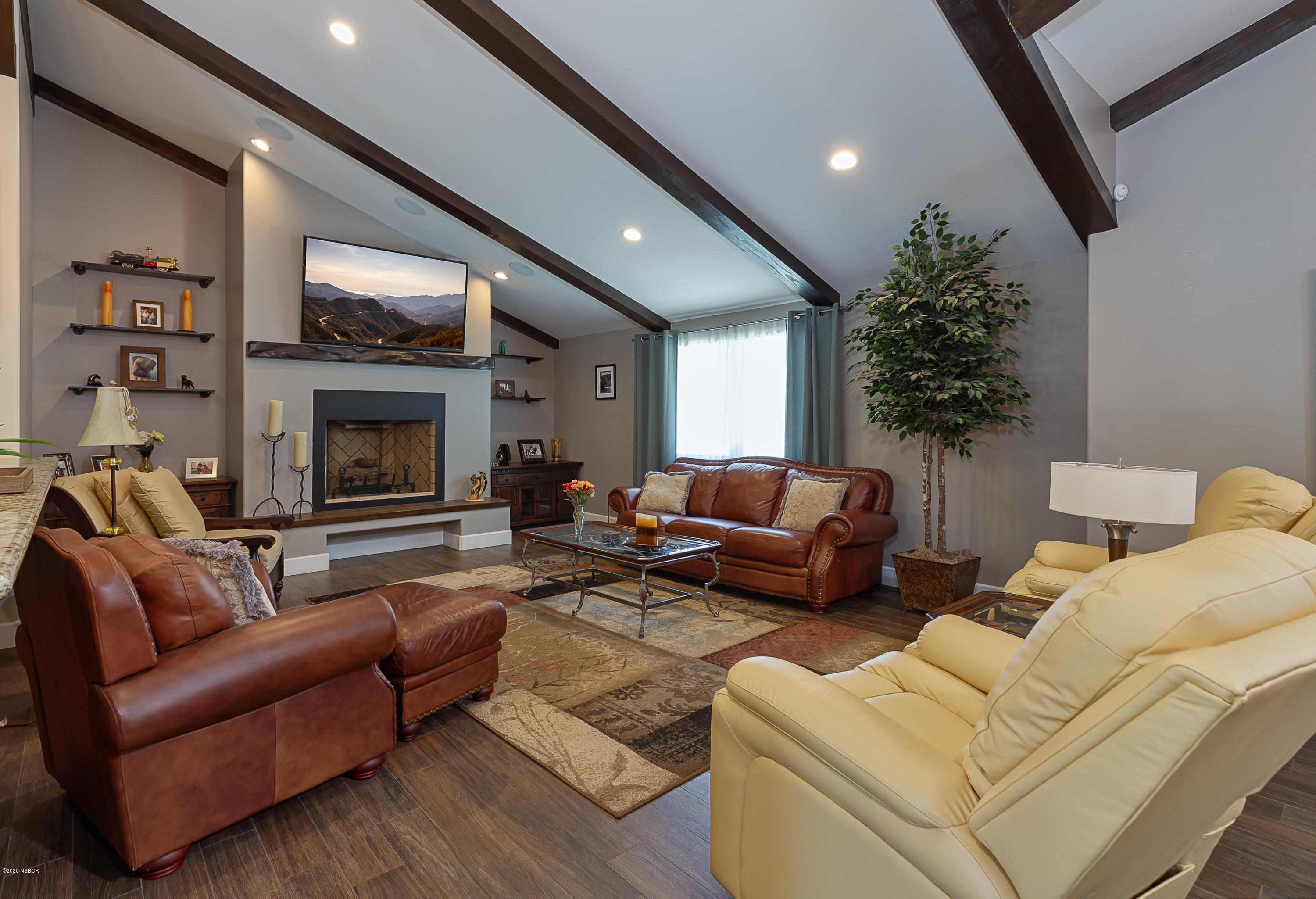 2550 Elk Grove Road Solvang, CA 93463 - Photo 5 of 28 a living room with furniture flat screen tv and a fireplace