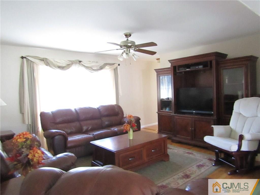 25 Brandeis Road Old Bridge, NJ 08859 - Photo 2 of 25 a living room with furniture and a flat screen tv