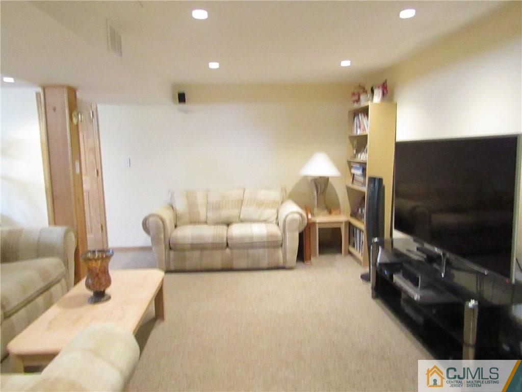 25 Brandeis Road Old Bridge, NJ 08859 - Photo 12 of 25 a living room with furniture and a flat screen tv