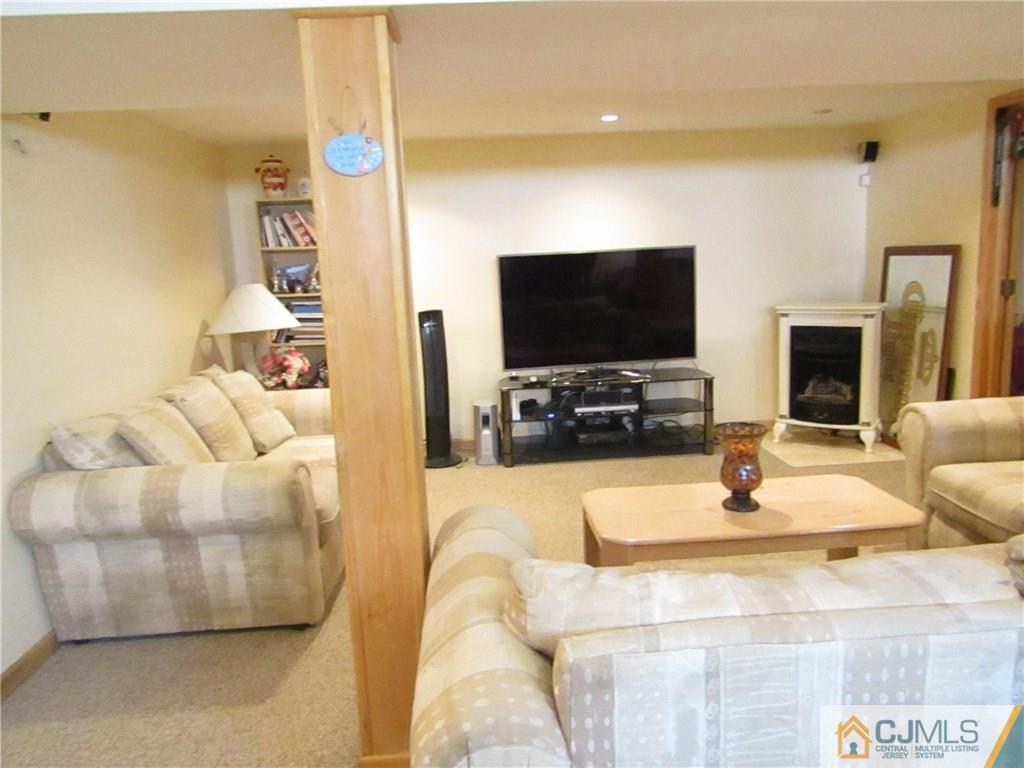 25 Brandeis Road Old Bridge, NJ 08859 - Photo 13 of 25 a living room with fireplace furniture and a flat screen tv