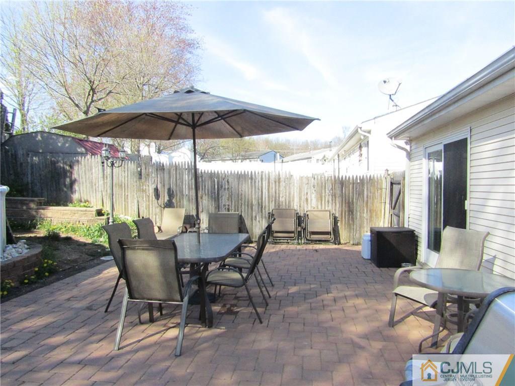 25 Brandeis Road Old Bridge, NJ 08859 - Photo 16 of 25 a view of a dining table and chairs in the patio