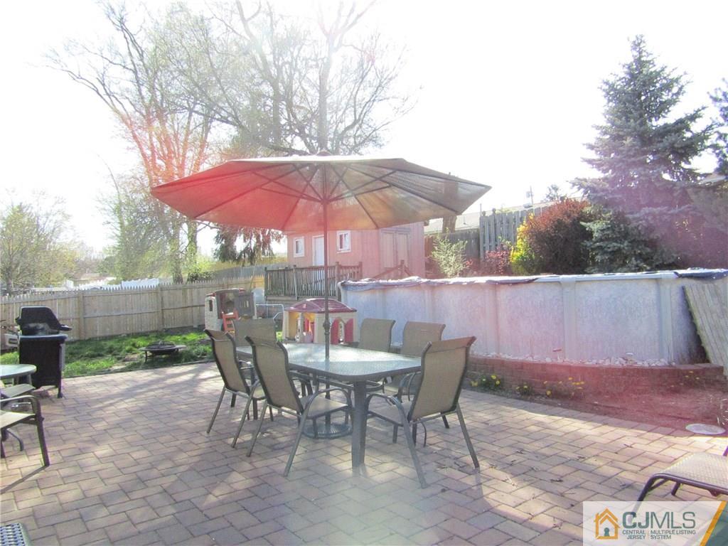25 Brandeis Road Old Bridge, NJ 08859 - Photo 17 of 25 a patio with a patio table and chairs