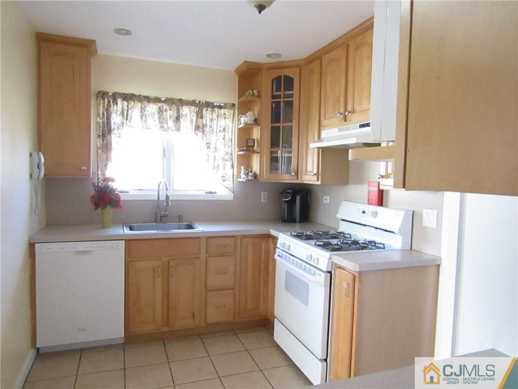25 Brandeis Road Old Bridge, NJ 08859 - Photo 3 of 25 a kitchen with a stove sink and cabinets