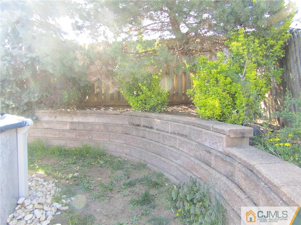 25 Brandeis Road Old Bridge, NJ 08859 - Photo 21 of 25 a view of a yard with plants and large trees