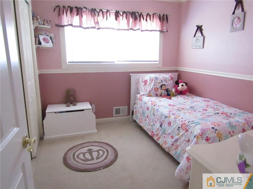 25 Brandeis Road Old Bridge, NJ 08859 - Photo 8 of 25 a bedroom with a bed and a window