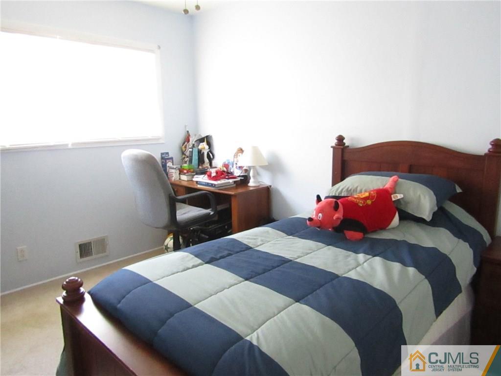 25 Brandeis Road Old Bridge, NJ 08859 - Photo 10 of 25 a bedroom with a bed and a potted plant