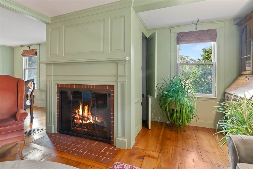 63 Ferry Road Salisbury, MA 01952 - Photo 16 of 42 a living room with a fireplace and a potted plant