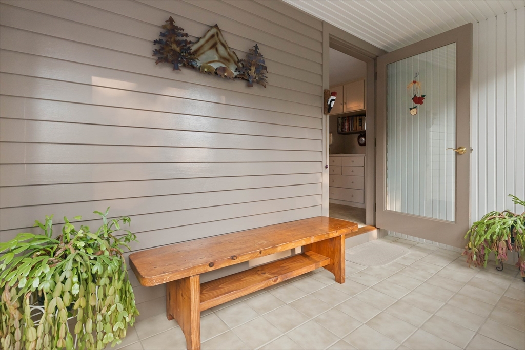63 Ferry Road Salisbury, MA 01952 - Photo 24 of 42 a backyard with a bench and potted plant