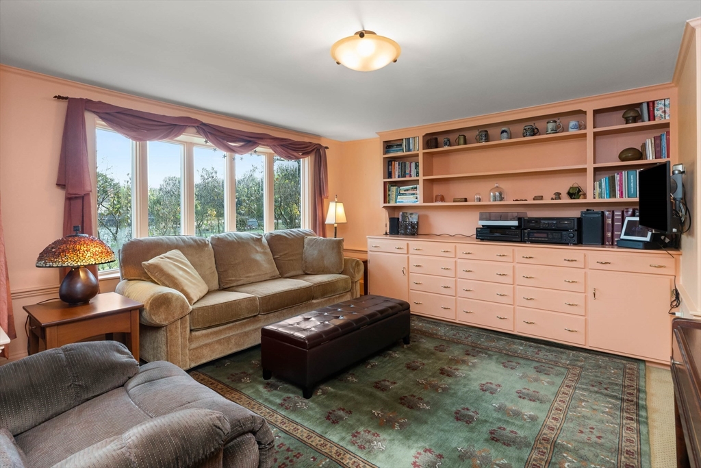 63 Ferry Road Salisbury, MA 01952 - Photo 25 of 42 a living room with furniture flat screen tv and a fireplace