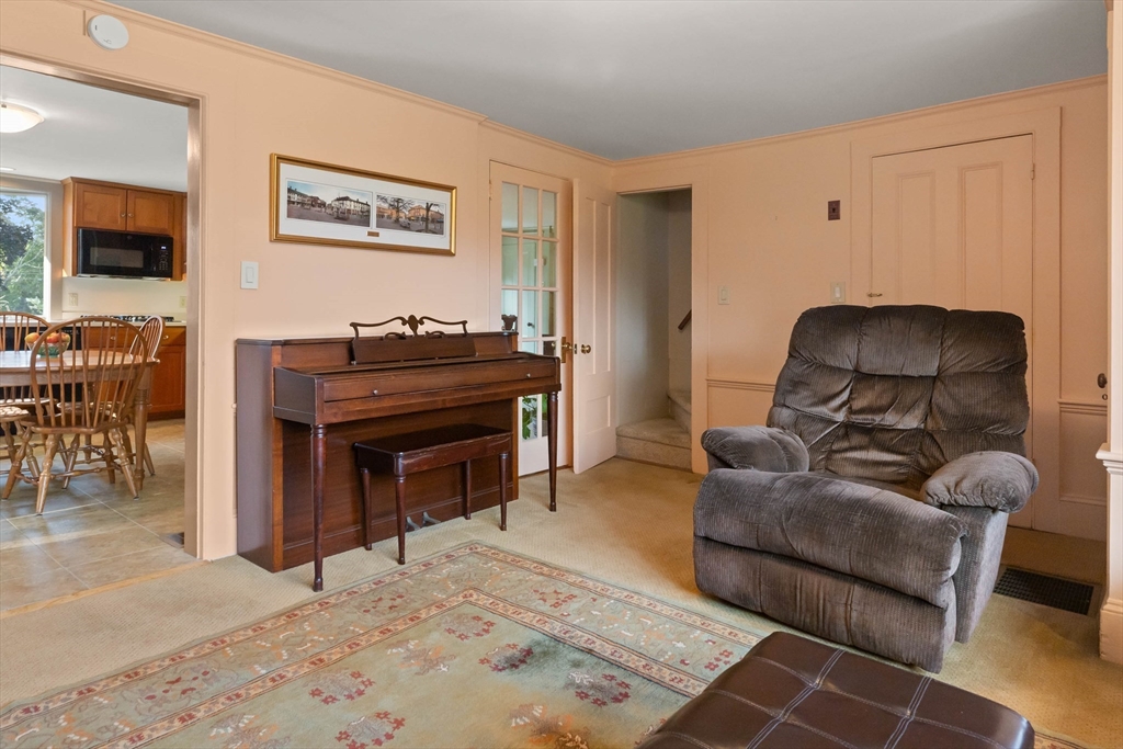 63 Ferry Road Salisbury, MA 01952 - Photo 26 of 42 a living room with furniture a flat screen tv and a piano