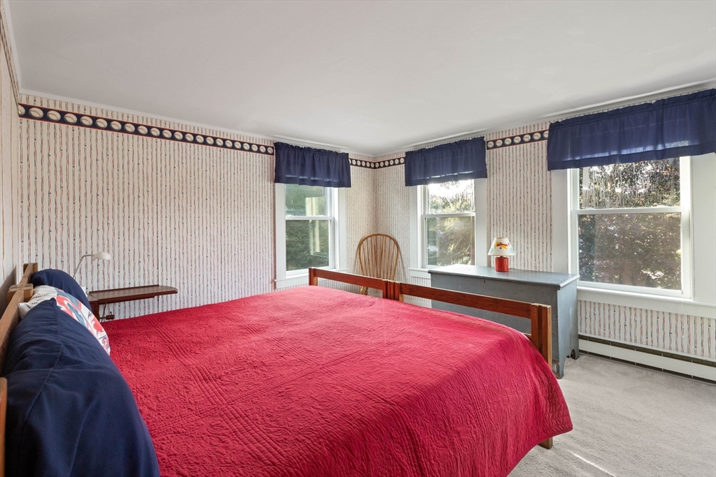 63 Ferry Road Salisbury, MA 01952 - Photo 32 of 42 a bed sitting in a bedroom next to a window