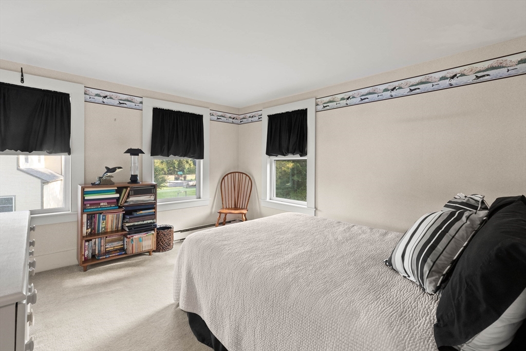 63 Ferry Road Salisbury, MA 01952 - Photo 35 of 42 a bedroom with a bed and a flat screen tv