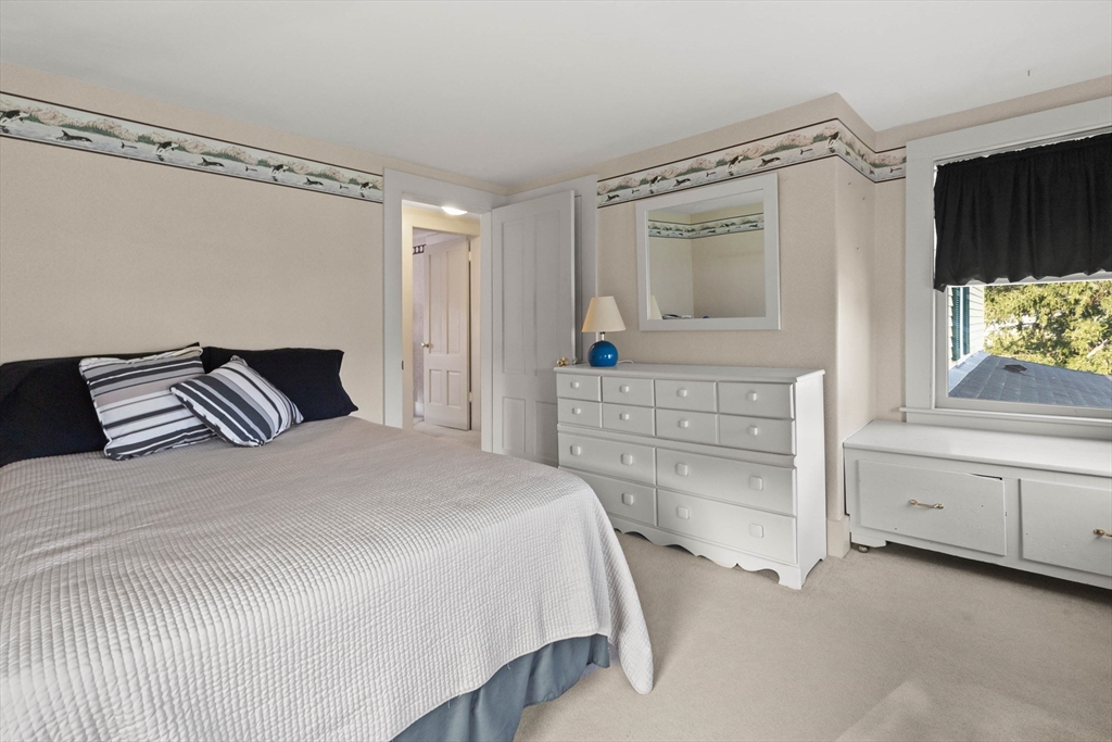 63 Ferry Road Salisbury, MA 01952 - Photo 36 of 42 a bedroom with a bed and a window