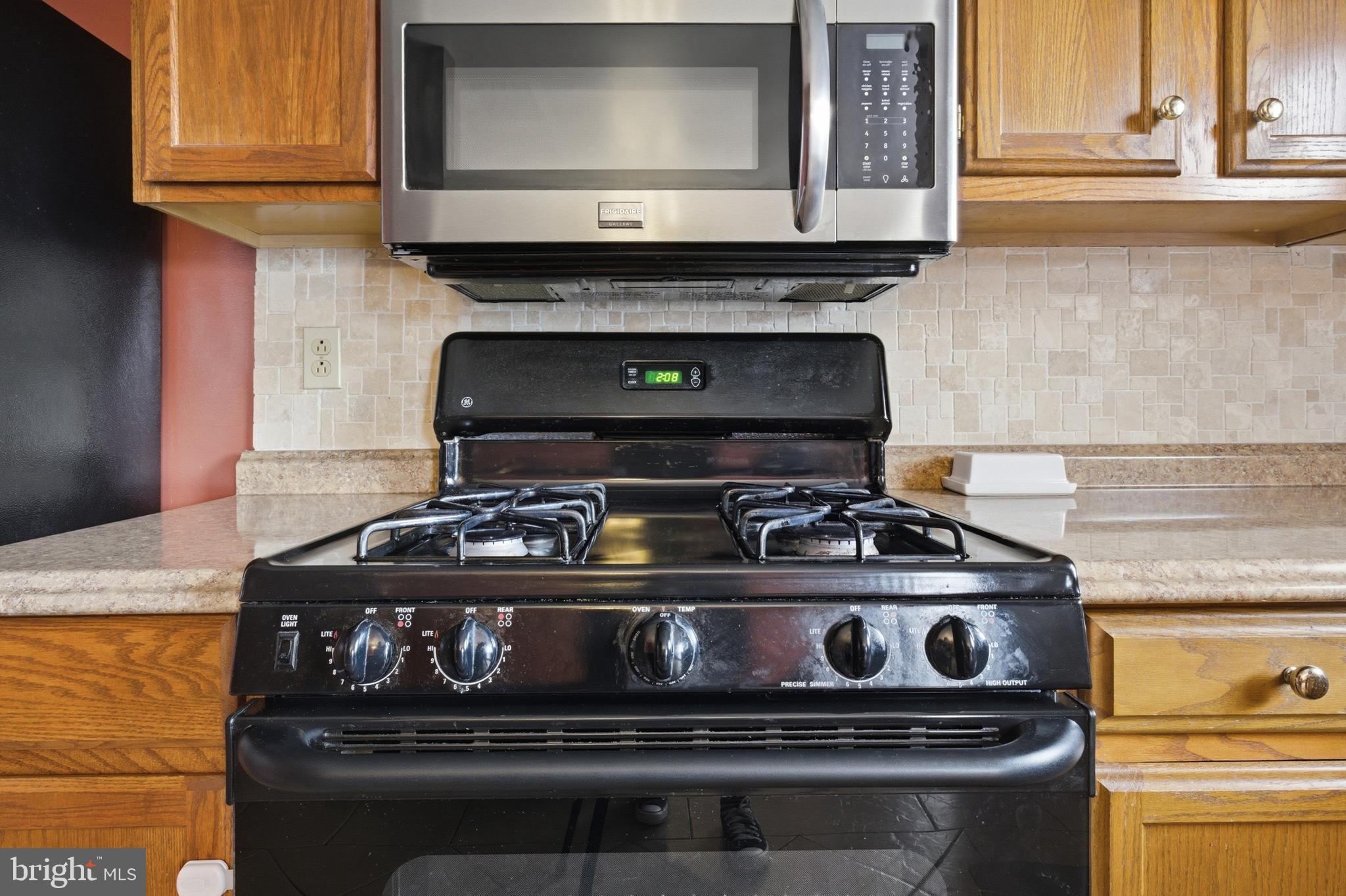 1302 Carbon Street Reading, PA 19601 - Photo 12 of 24 a stove top oven sitting inside of a kitchen
