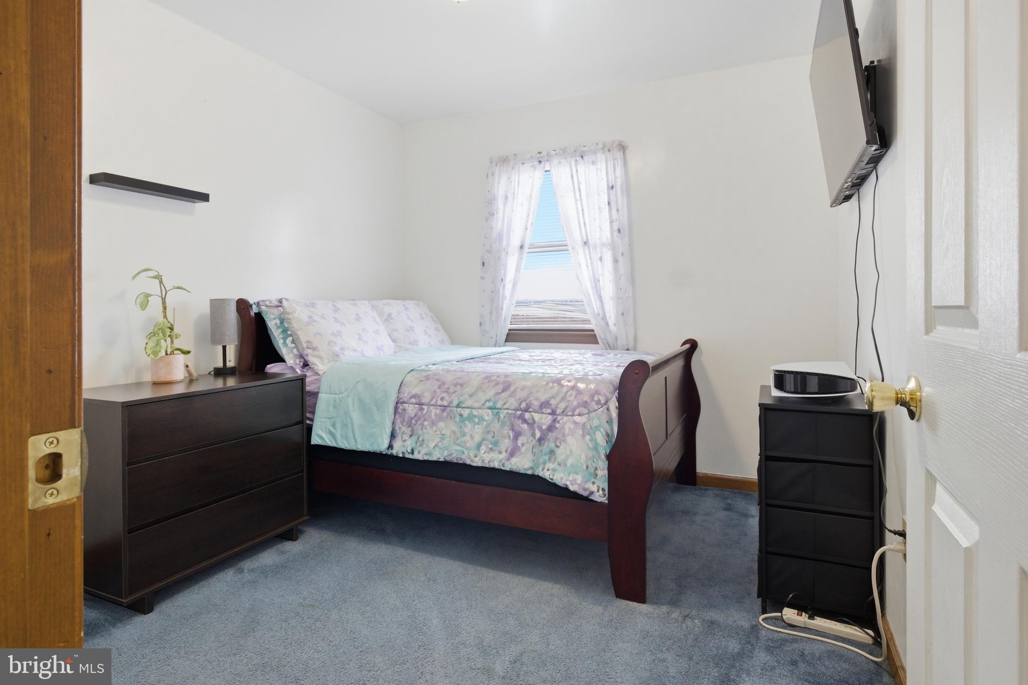 1302 Carbon Street Reading, PA 19601 - Photo 13 of 24 a bedroom with a bed and a window