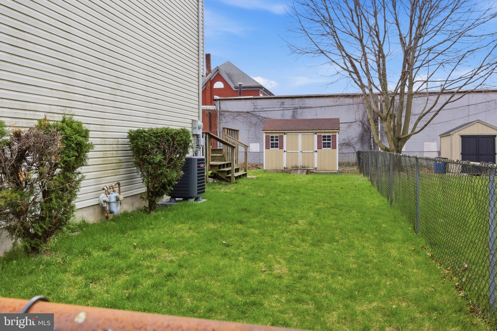 1302 Carbon Street Reading, PA 19601 - Photo 24 of 24 a front view of a house with a yard and trees