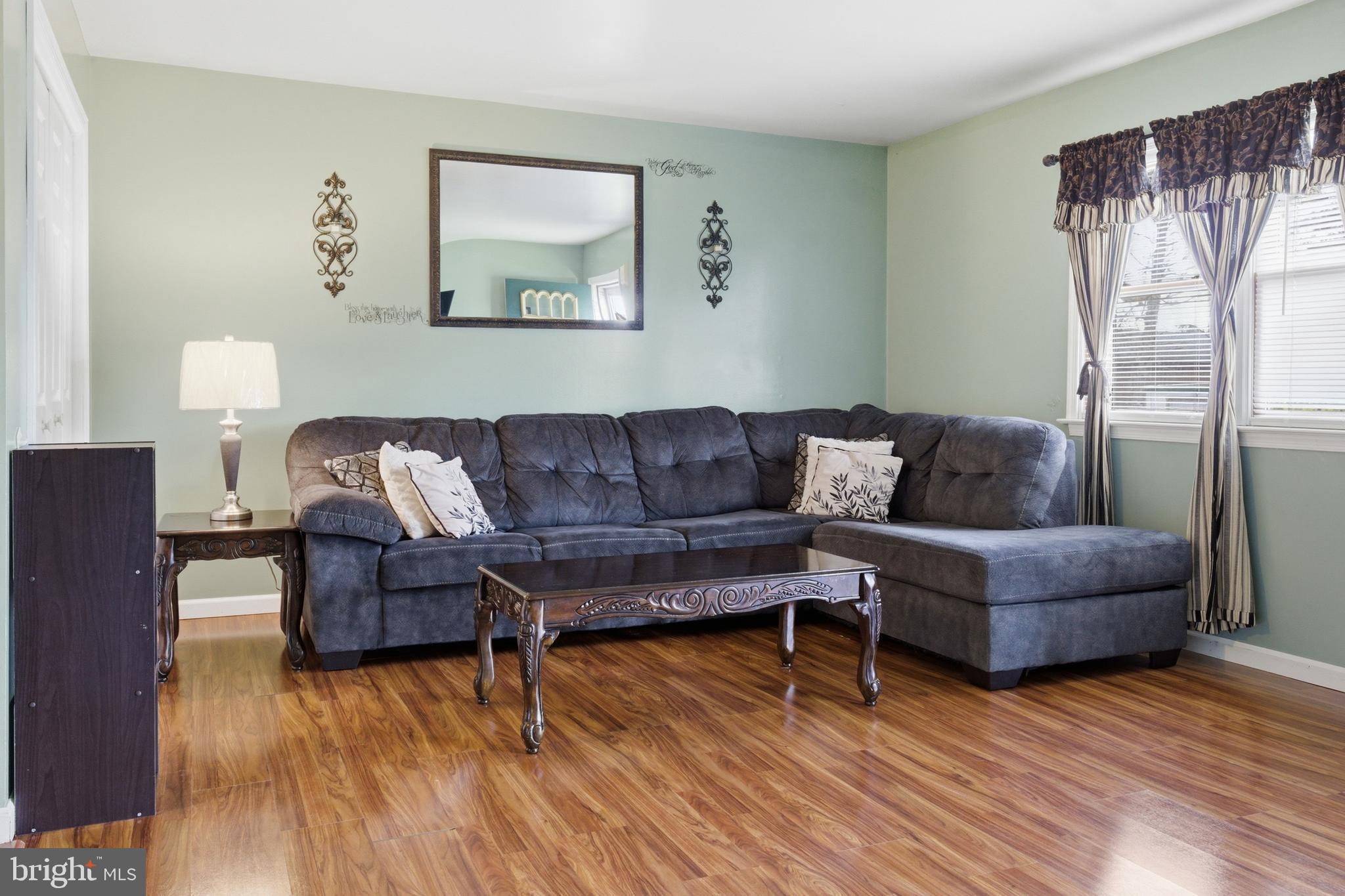1302 Carbon Street Reading, PA 19601 - Photo 5 of 24 a living room with furniture and a wooden floor