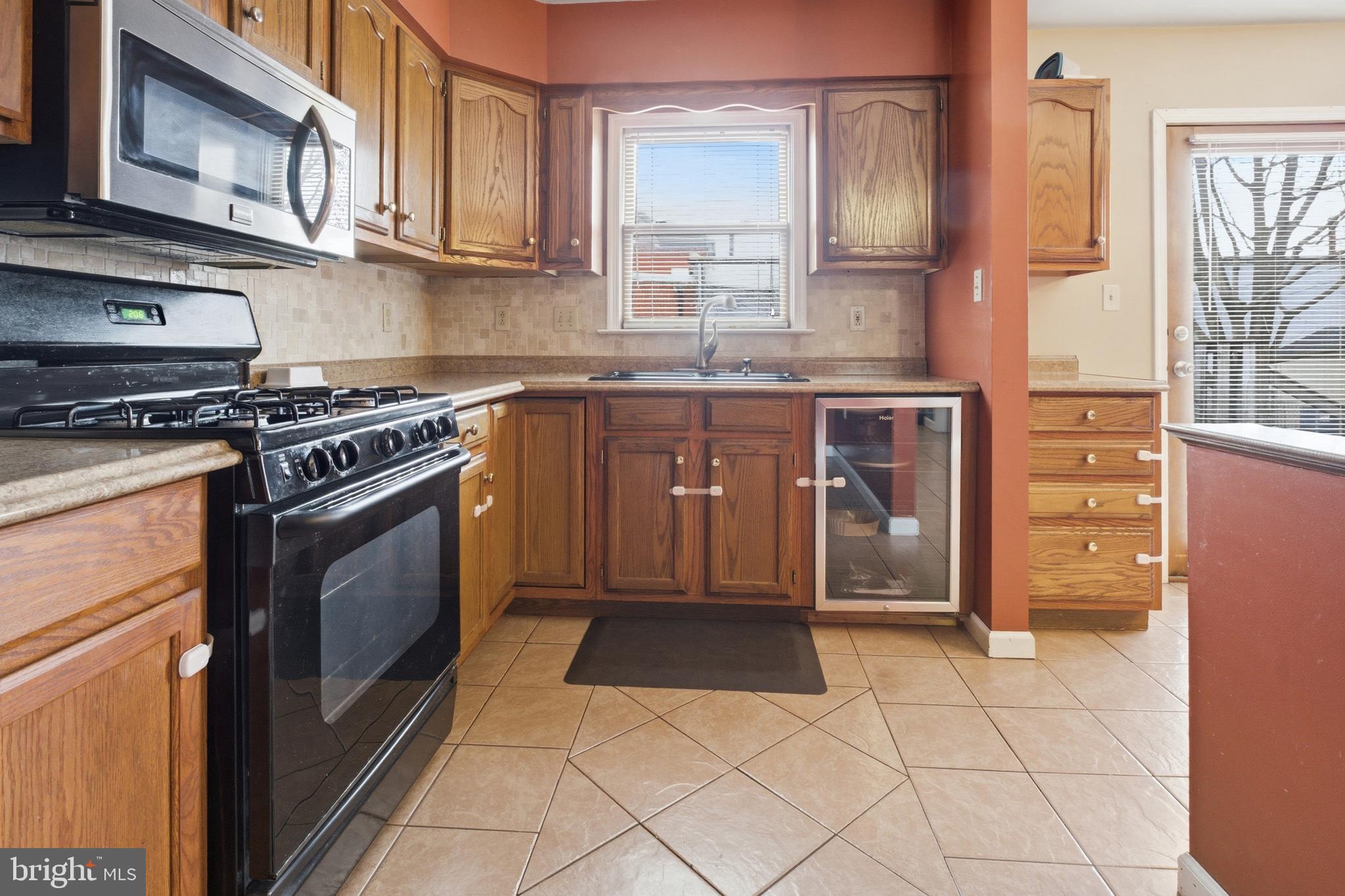 1302 Carbon Street Reading, PA 19601 - Photo 10 of 24 a kitchen with granite countertop a stove a sink and a refrigerator