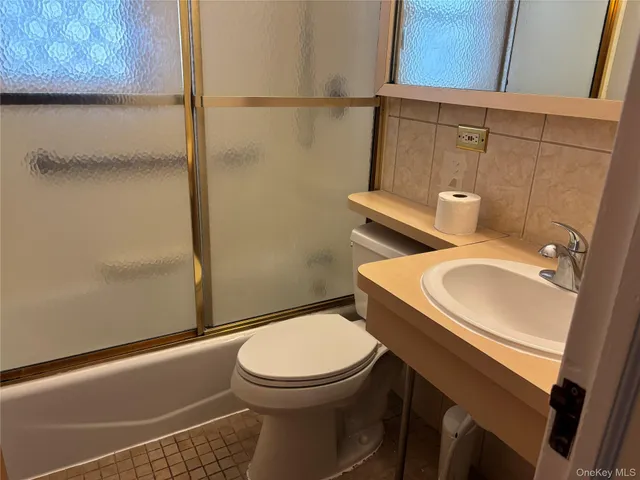 a white toilet sitting next to a bathroom sink