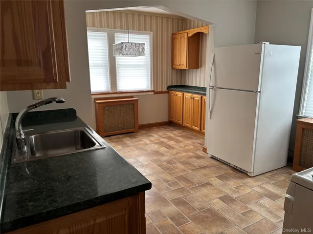 a kitchen with a refrigerator and a sink