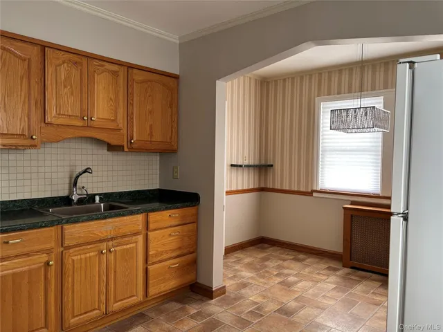 a kitchen with stainless steel appliances granite countertop a refrigerator sink and cabinets