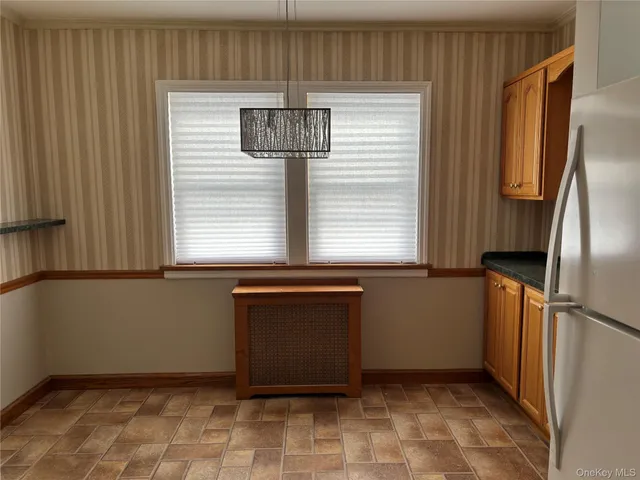 a kitchen with stainless steel appliances a refrigerator and a window