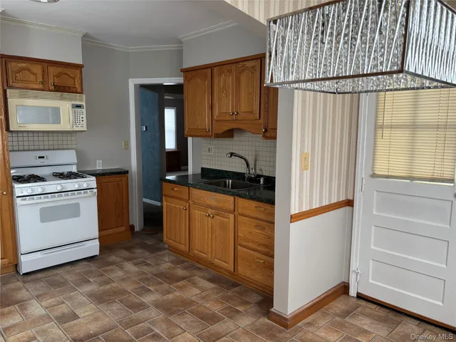 a kitchen with granite countertop cabinets and appliances