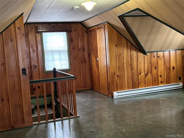 a view of a room with wooden walls