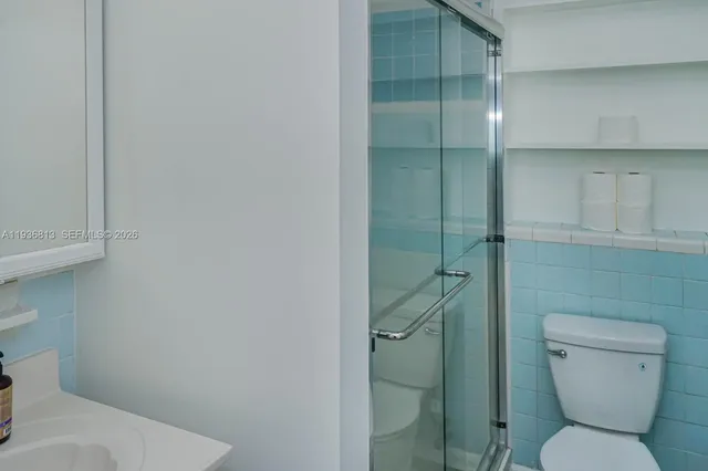 a bathroom with a toilet and a shower