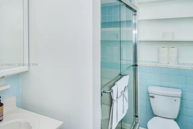 a bathroom with a toilet and a shower