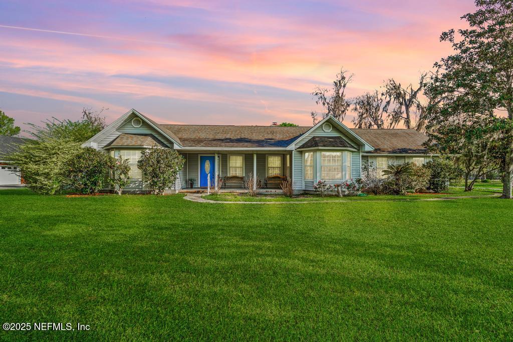 a front view of a house with a garden
