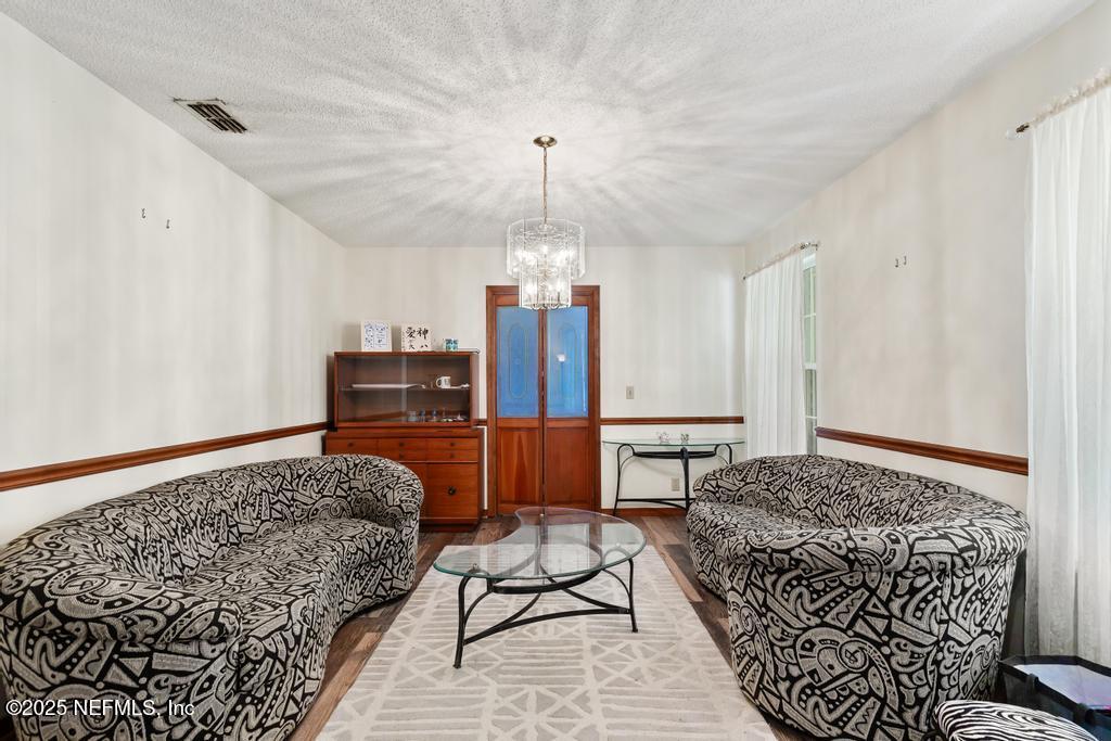 45235 Stratton Road Callahan, FL 32011 - Photo 12 of 44 a bedroom with a bed and a chandelier