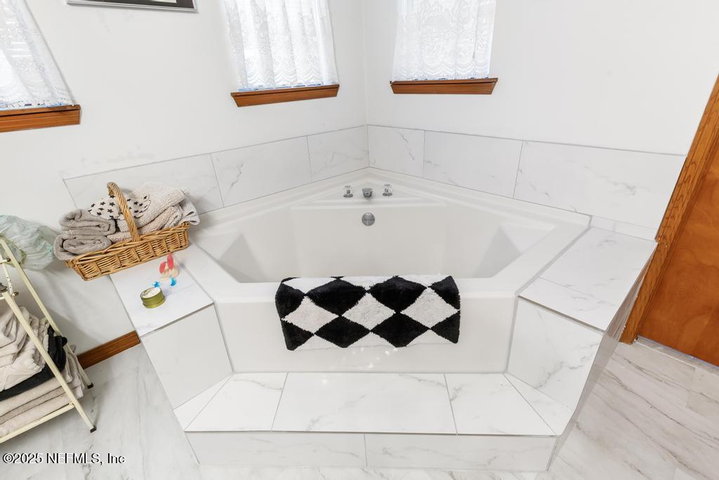 45235 Stratton Road Callahan, FL 32011 - Photo 16 of 44 a bathroom with a bathtub and sink