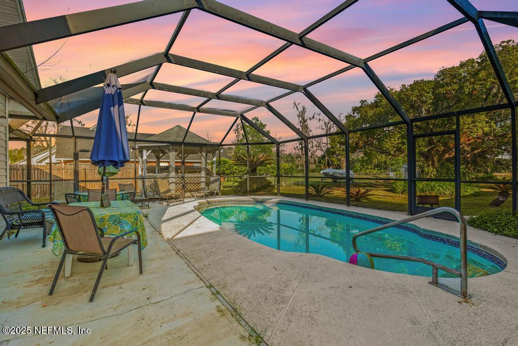 45235 Stratton Road Callahan, FL 32011 - Photo 2 of 44 a view of a swimming pool with a patio and a yard