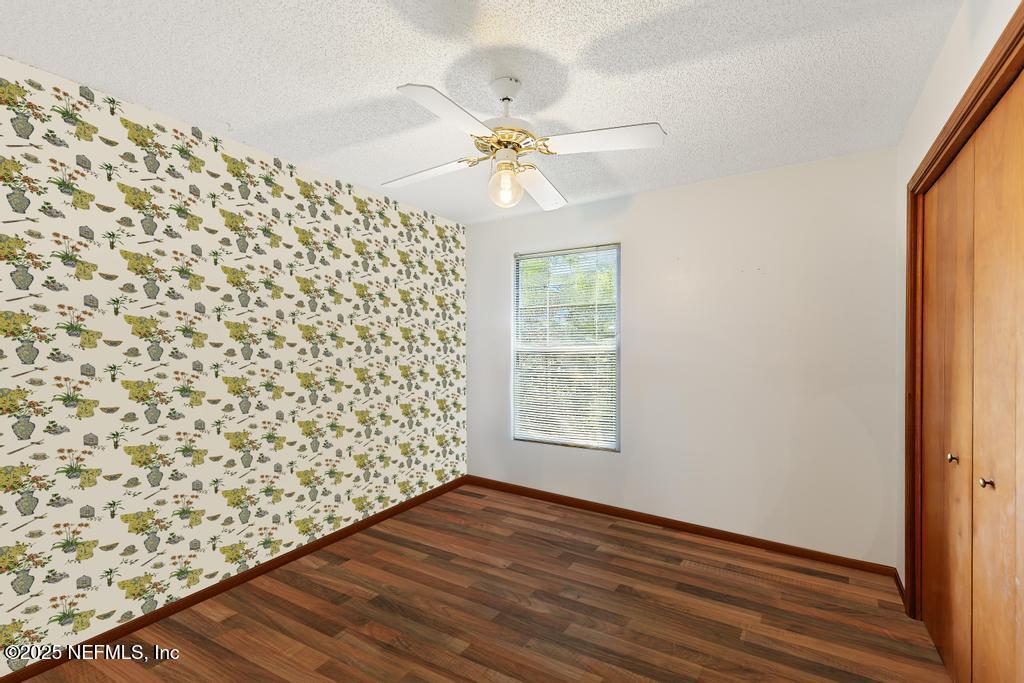 45235 Stratton Road Callahan, FL 32011 - Photo 24 of 44 an empty room with wooden floor fan and windows