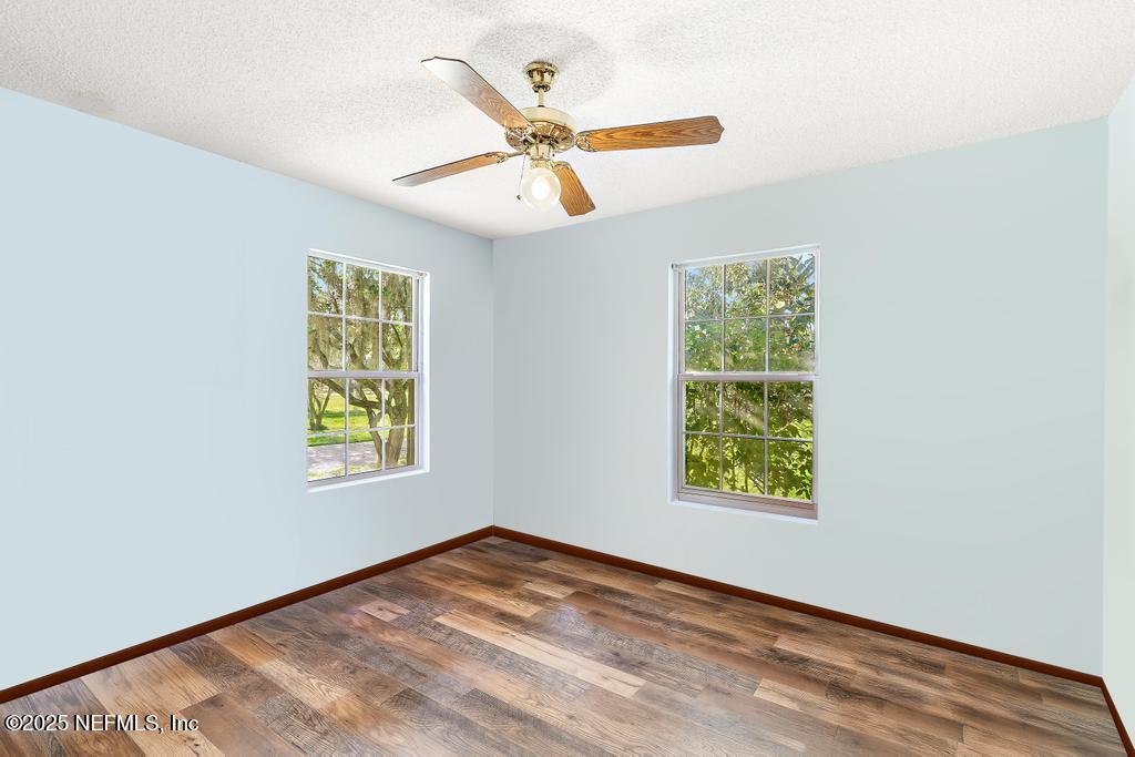 45235 Stratton Road Callahan, FL 32011 - Photo 26 of 44 an empty room with windows and ceiling fan
