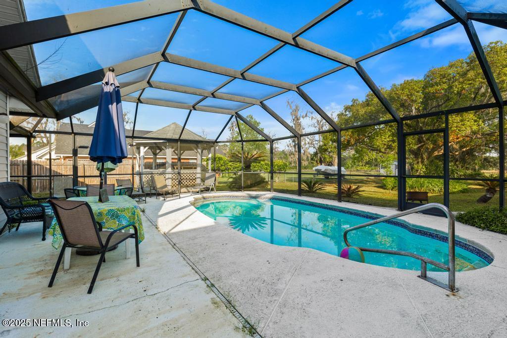 45235 Stratton Road Callahan, FL 32011 - Photo 32 of 44 a view of a swimming pool with a porch