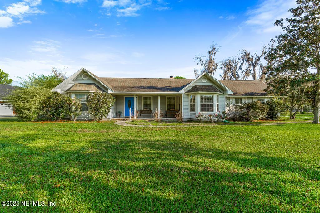 45235 Stratton Road Callahan, FL 32011 - Photo 7 of 44 a front view of a house with a garden